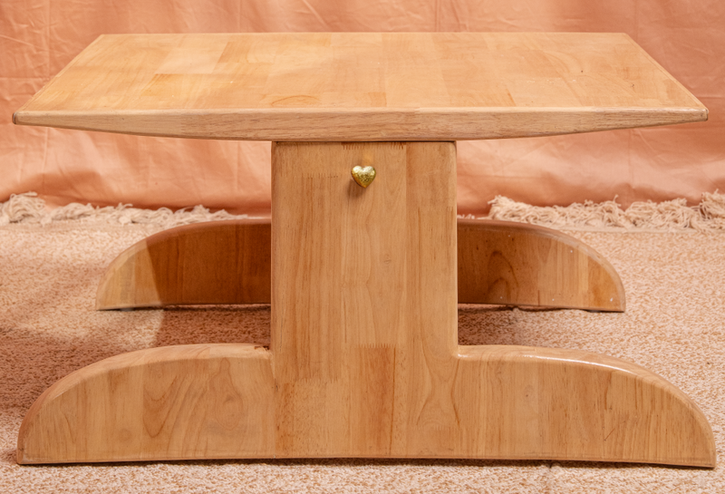 Wooden table with a unique design on a textured surface